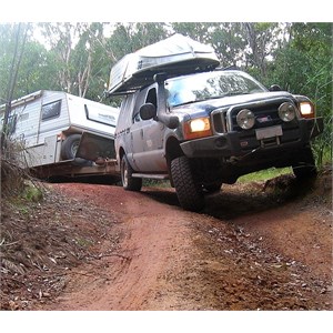 Off road caravan being towed on a bumpy track
