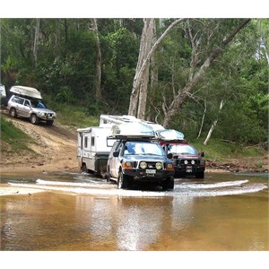 4WDs and off road caravans crossing a creek