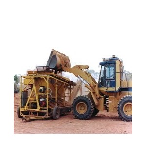 Front end loader tipping earth and rocks into a modern dryblower