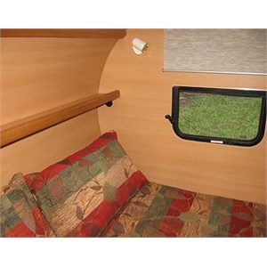Inside a teardrop camper showing the bed