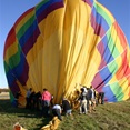 Everyone helps to roll up the balloon