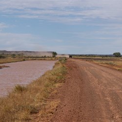 Roadside water as the Hummer thunders west to Mulan