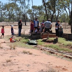 Aretsion bore that is capped to produce a restricted flow rate