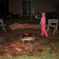 Chardae helps cook the sausages