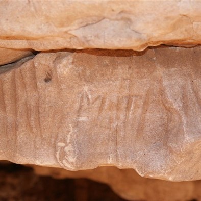 Grooves left by the sharpening of spears (and Michael Tobins initials) - Well 38 CSR