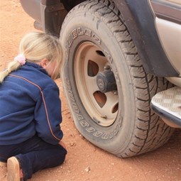 Chardae inspects the flat tyre