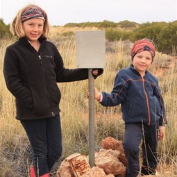 Leah and Chardae at the rockhole commemorating the site from where the last aboriginals were taken to civilisation in 1977
