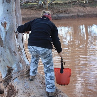 Michelle getting creek water for showers