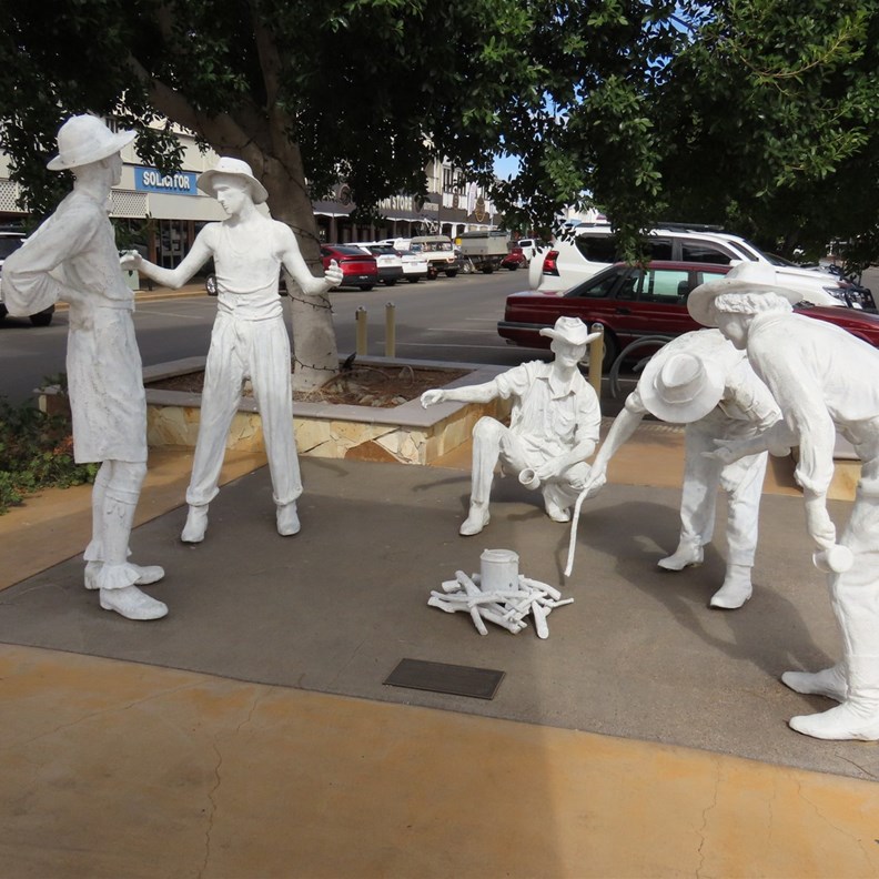 Brass Statues painted white as people burnt there hands touching them
