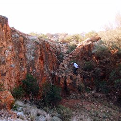 Dr Kris climbing the waterfall to get to the waterhole