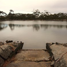 Walls to channel water into the dam
