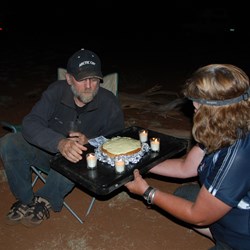 Suzette the masterful bush chef presenting Scotty with his birthday cake