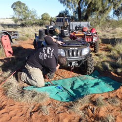Clearing out spinifex and plant material from the quad radiator