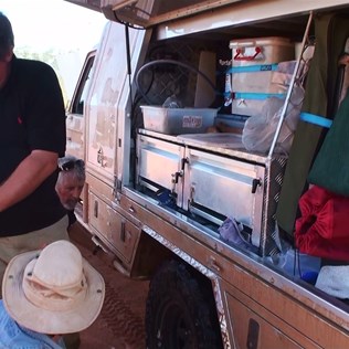 The pit crew in action.  Recharging the spray bottle.