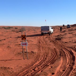 A sign and no visible track before us