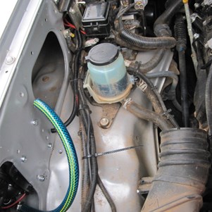 Wark area with air filter box removed- Wiring protrudes from hole just before second port