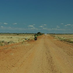pushbike rider on the track between Oodnadatta and Marla