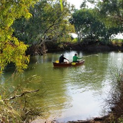 the canoe and men on the water at hookeys waterhole