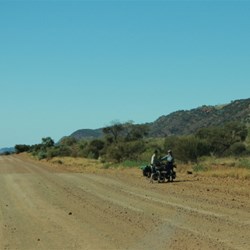 two cyclists take a break on the road