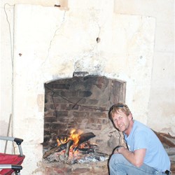 Johnno seeking warmth (or a stick to light his durrie)