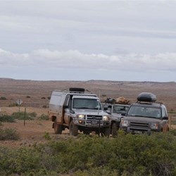 The convoy with the arid expanse of the Pedirka Desert in the background
