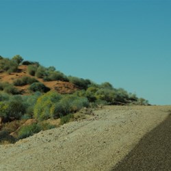 red sand dune on a road crest