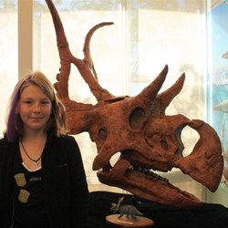 Leah with dinosaur skull cast in Big Water Utah
