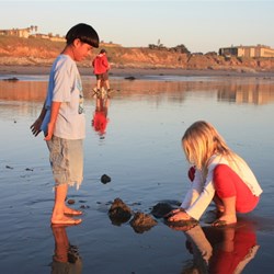 Kids playing in mud at San Simeon beach