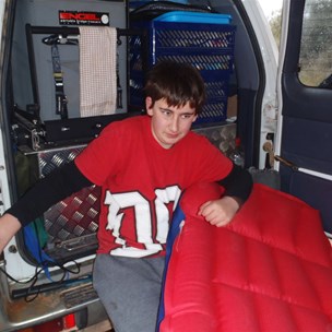 Riley preparing his bed for the evening and trying to stay dry.