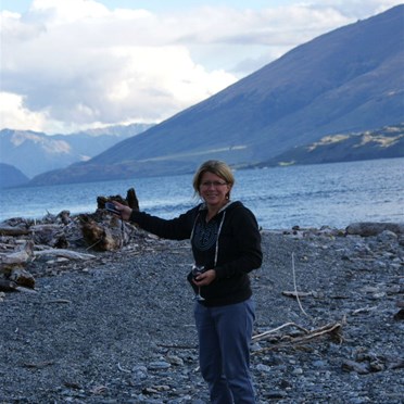 Vik by the shores of Lake Wanaka with traveller (Note glass of red)