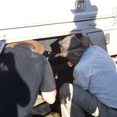 The men sorting out the right rear wheel issue