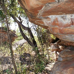 Two figures in a sheltered overhang
