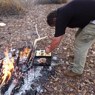 Masterful bush chef preparing a hearty Hamersley breakfast