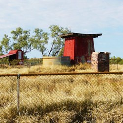 Raised henhouse in background, water tank and stand in the foreground