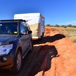 over a small red roadside sandy edge to get back on to track after detour