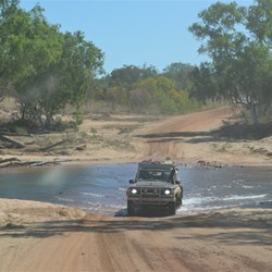 A car crossing the Gibb River. 1KM or so up the Kalumbaru rd.