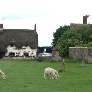 Thatched pub and a stone from one of the smaller inner stone circles