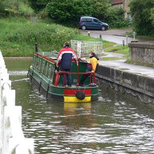 Narrow boat crossing over the river