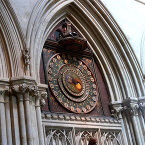 Old clock face and jousting knights above