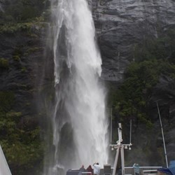 Nudging under one of the many spectacular waterfalls