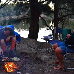 Cooking dinner on the fire.