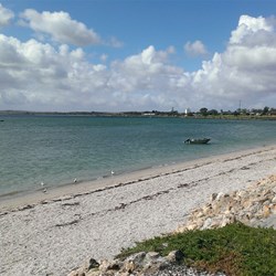 the beach in front of the waterfront sites in the van park