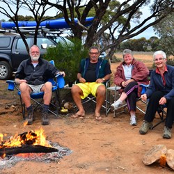 Happy campers with roaring fire