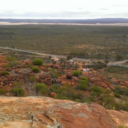 looking down on our van and car, a tiny dot beside a road train in the car park