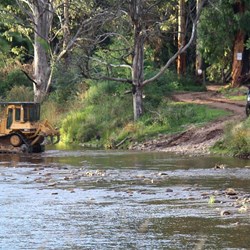 Bulldozer crossing Wonnangatta River at Eaglevale