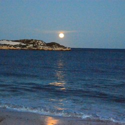 moon setting over ocean