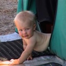 Leah crawling out of tent