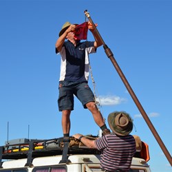 David putting the EO Flag on the old Wind Sock Pole