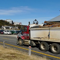 Tip trucks carrying timber away