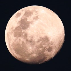A near full moon over the desert